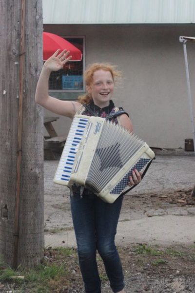 This was an absolutely lucky shot. This girl was playing the accordian and waving at cars passing by a general store in the Indiana Dunes in July 2013. I pointed the camera out the window, pressed the shutter and hoped for the best.